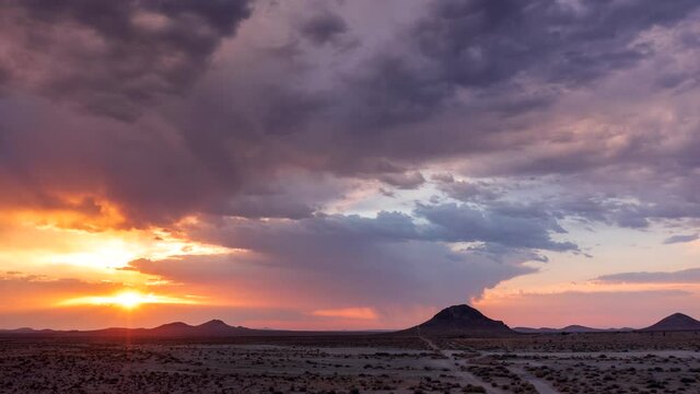 Pull back aerial hyper lapse during a stunning and colorful sunrise in the Mojave Desert