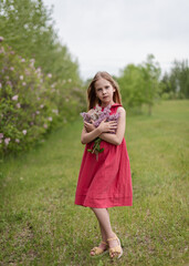 little girl with a syringa flowers