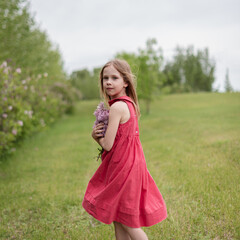 portrait of little girl with a syringa flowers