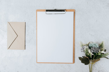 Note paper, letterhead and flowers placed on a white background.