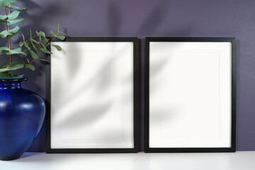 On trend shadow photography blank frame mockup featuring new season background color, gray blue. Negative copy space.