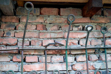 an old brick wall reinforced with iron bars