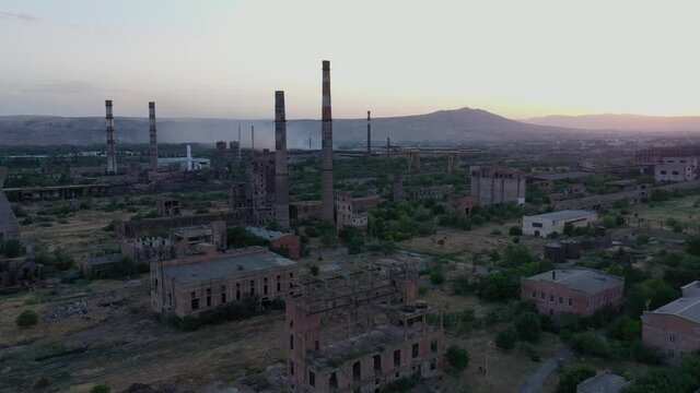 Approaching Towards Abandoned Factory In Ghost Town At Daytime. Akarmara In Abkhazia, Georgia. drone forward