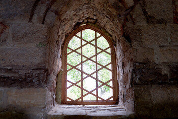 Fototapeta na wymiar a window in a castle with stone walls and bars