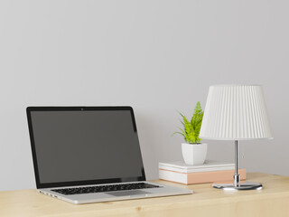 Fototapeta premium A working room with a laptop with a lamp placed on the table.