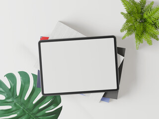 The tablet is placed on a white background and has green leaves.