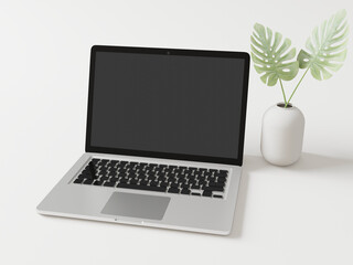 Fototapeta premium The laptop is placed on the floor with a vase and leaves.