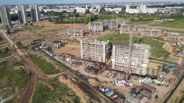 Tower crane during construction of a residential building. Cranes on formworks. Arial view of the construction a multi-storey homes. Renovation concept. Realtor and Real Estate. Buildings construction