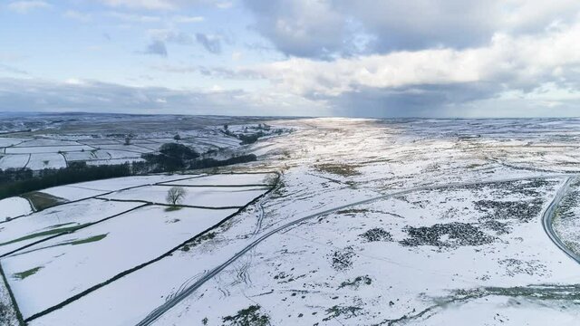 North York Moors Snow Scene Drone Flight, Castleton, Westerdale, Rosedale, Flight over Castleton, reveal pan upwards, Winter cold and moody clouds, Phantom 4, Clip 11