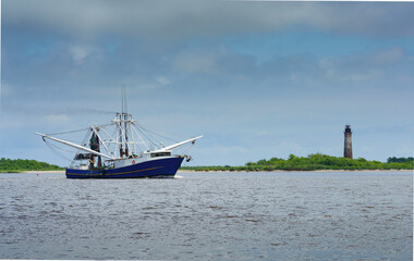 A shrimp boat on the Sabine River heading into the Gulf of Mexico past the historic Sabine Pass...