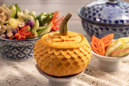 pumpkin carved into flowers on table in restaurant for Thai food and fruits and vegetables carved background.  art of Thai fruit and vegetable carving
