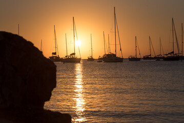 Yachts in Cala Saona Beach in Formentera in Spain in summer 2021.