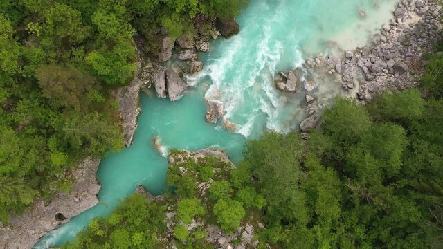 Aerial - Majestic grey Soča river rapids, surrounded by a softwood forest 