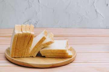 Sliced bread bake on wooden tray. Simple breakfast