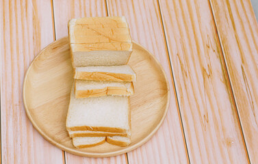 Sliced bread bake on wooden tray. Simple breakfast