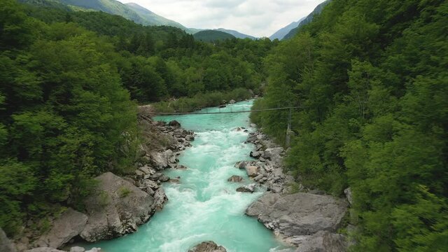 Aerial &ndash; Flying over a majestic emerald Soča river running through spring forest