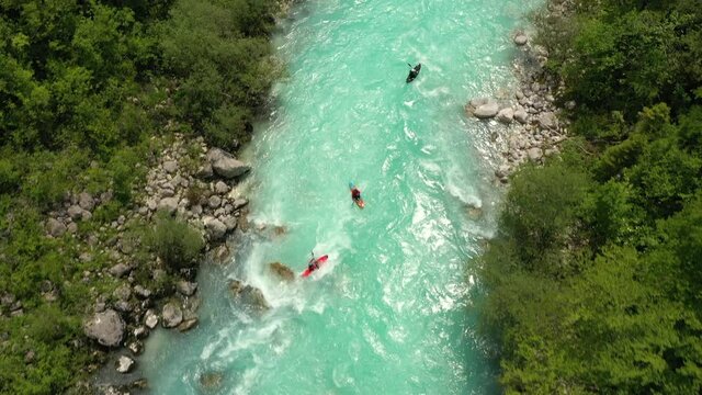 Aerial - Birds' view of three kayaks on a beautiful Soča river