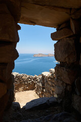 View from inside the Inca ruins on the sun island or Isla del Sol overlooking Lake Titicaca, Bolivia. Vertical photo.