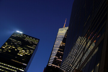 New York, NY - March 27, 2014: 42nd Street view of a building at night reflecting in the city