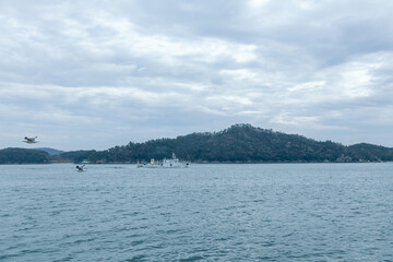 fishing boat on the water with cloudy sky