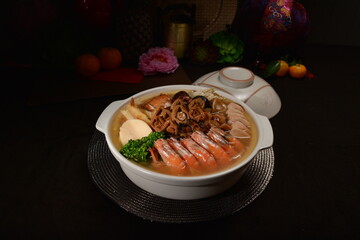 braised premium seafood mixed in clay pot Peng cai with big prawn, herbal, abalone mushroom, vegetables for banquet menu