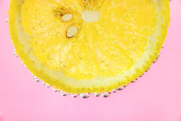 Lemon and line drop in fizzy sparkling water, juice refreshment