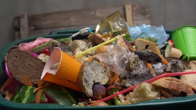 Organic waste, unsold food, uneaten bread, plastic in the trash can. The food throw out in household, home kitchen or in restaurant. Food loss and waste reduction