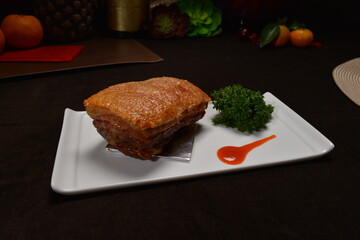 crispy roasted bbq pork belly meat cut slices in long plate Hong Kong banquet menu