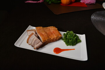 crispy roasted bbq pork belly meat cut slices in long plate Hong Kong banquet menu