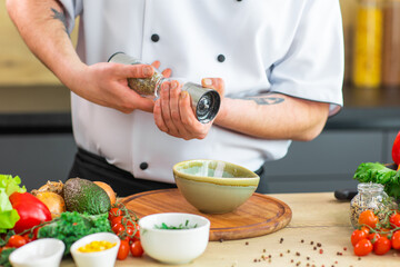 The man prepares food at home. Cooking healthy and tasty food.