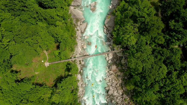 Aerial - Top view of a beautiful Soča river with kayakers going down the water