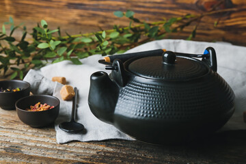 Obraz na płótnie Canvas Tea pot of hot beverage on wooden table