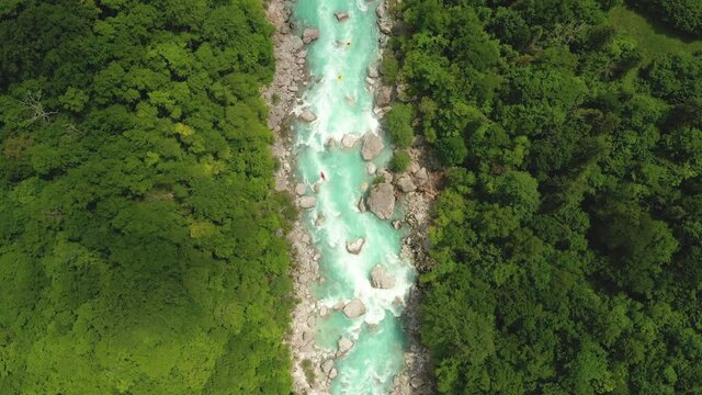 Aerial - A majestic turquoise Soča river with rapids and kayaks riding on it