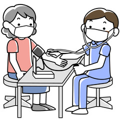 血圧測定をする男性看護師