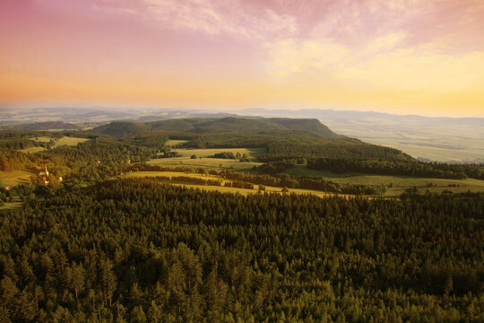 View from Great Szczeliniec, Szczeliniec Wielki highest peak of Stolowe Mountains to small, historic village of Pasterke and Czech part of Table Mountains with Koruna and Bozanovski Spicak peak Poland