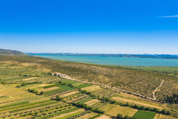Fototapeta na wymiar Aerial view of countryside landscape, Vransko lake and agriculture fields, Dalmatia, Croatia