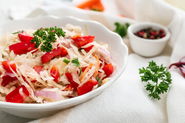 Plate with tasty sauerkraut on light background