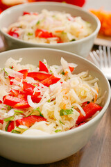 Bowls with tasty sauerkraut on table