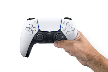 Male hand holding a Next Generation white game controller isolated on white background. © Diego