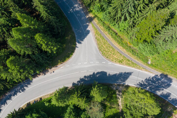 New asphalt road with retaining walls. Beautiful summer sunny day from above.  Aerial shot.