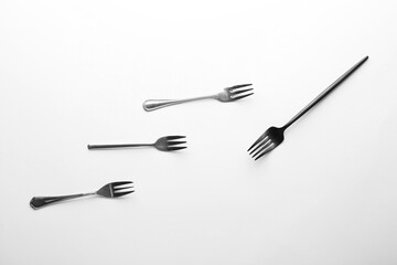 Fototapeta premium Different forks on white background. Concept of racism