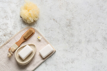 Soap bars and bath supplies on grunge background