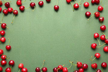 Frame made of tasty ripe cherry on color background