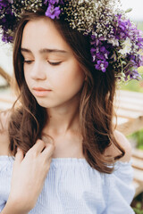 Cute 13-year-old child girl carrying basket of beautiful flower in the flower field with happiness