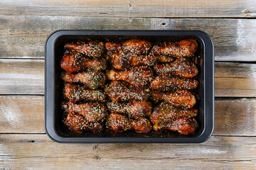 Overhead view of baked chicken legs on a baking tray