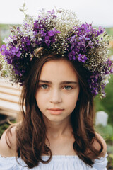 Cute 13-year-old child girl carrying basket of beautiful flower in the flower field with happiness