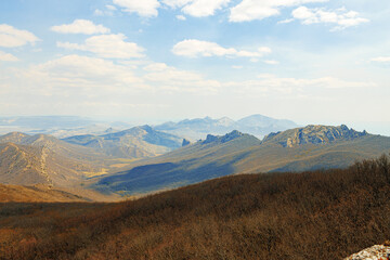 Mountains landscape against blue sky with clouds on sunny day