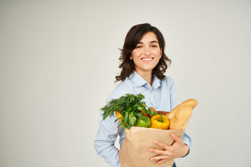 pretty brunette with package of organic food vegetables health