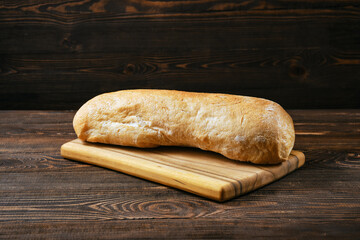 Freshly baked ciabatta on wooden table
