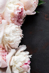Peony flowers on a black concrete background